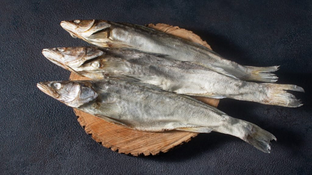On A Dark Background On A Wooden Substrate Lies A Large Dried Pike Perch Fish